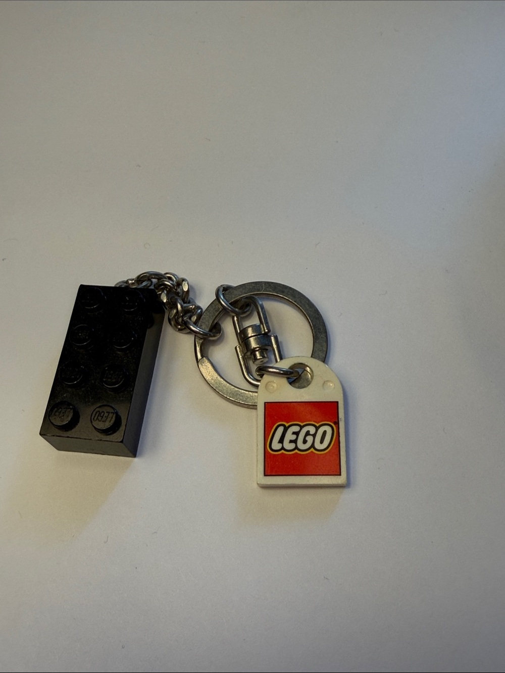 Lego Black Brick Keychain with White and Red Logo Tag